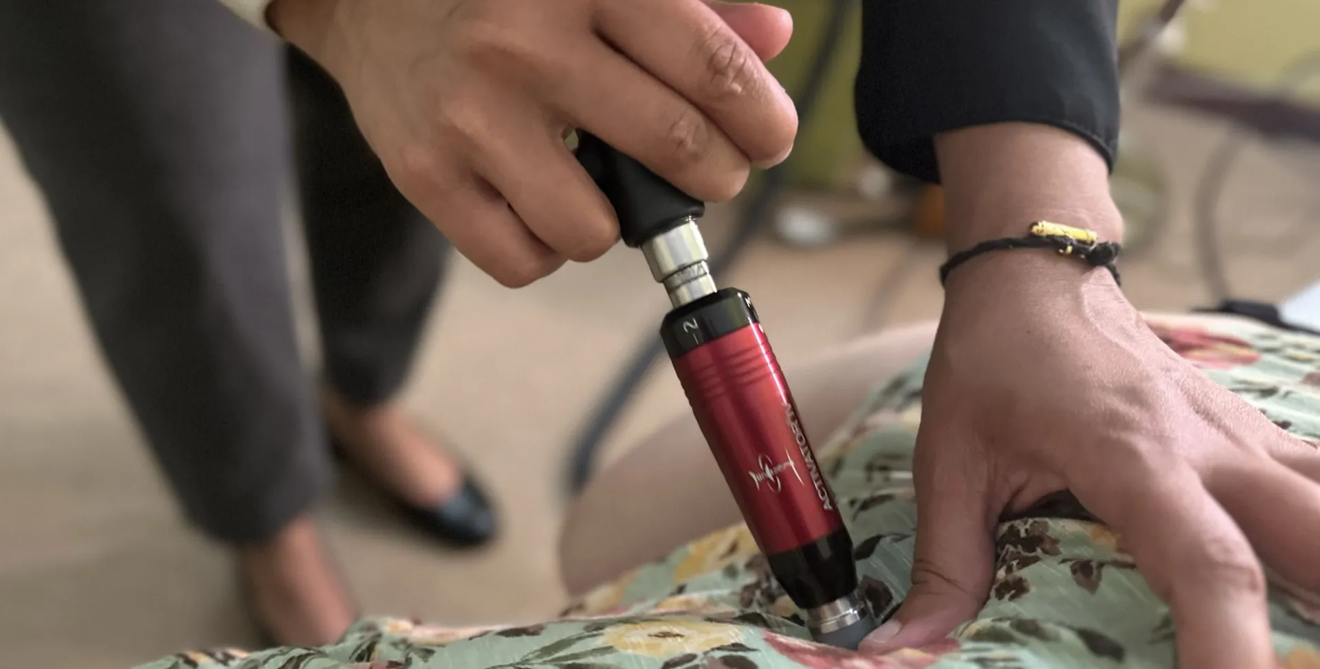 Dr. Chitra using the Activator instrument on a patient