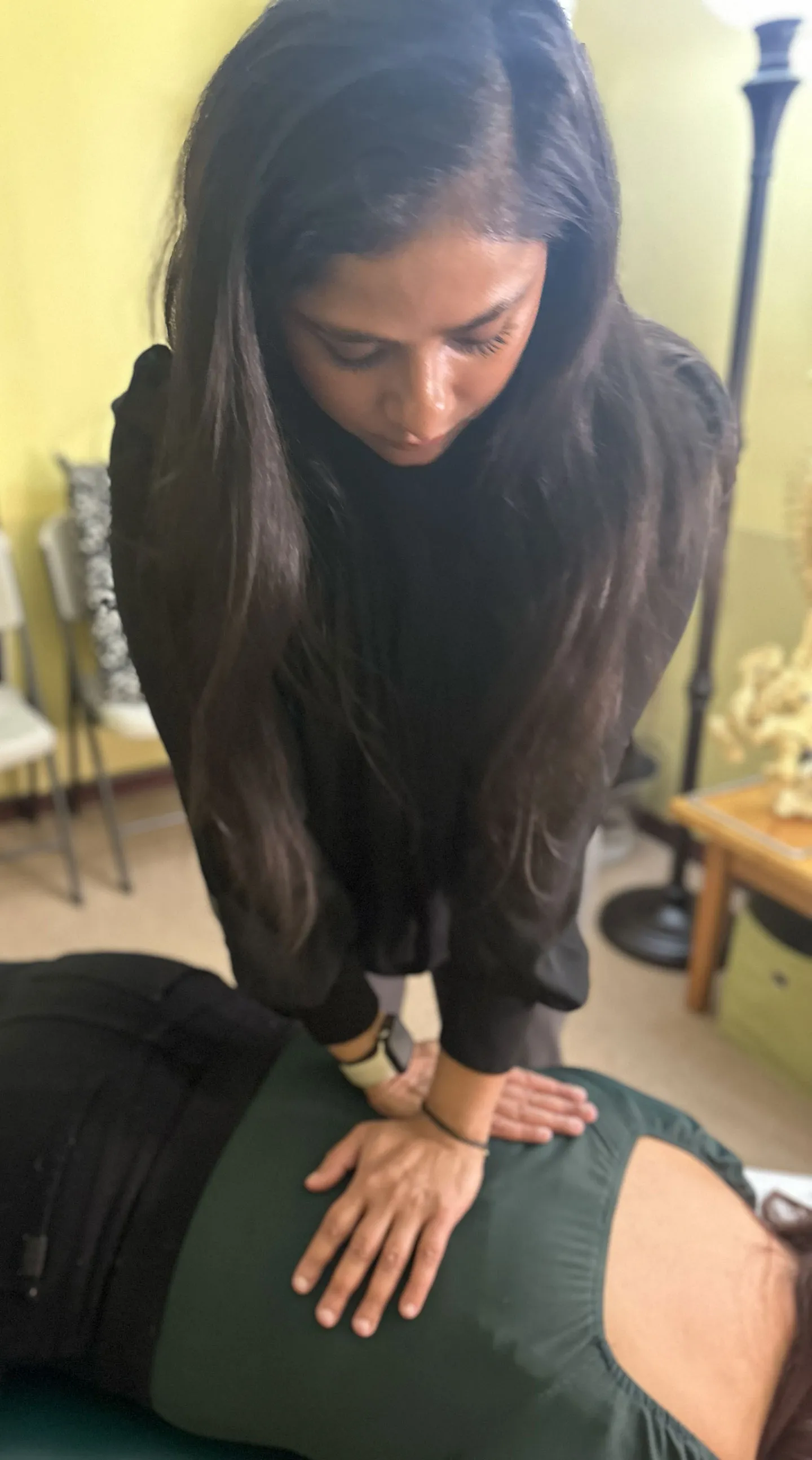 Dr. Chitra Rajendran treating a patient with back pain